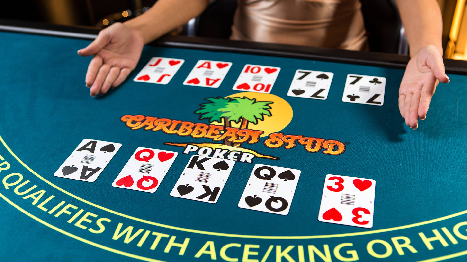poker table with cards scattered and caribbean poker stapled across