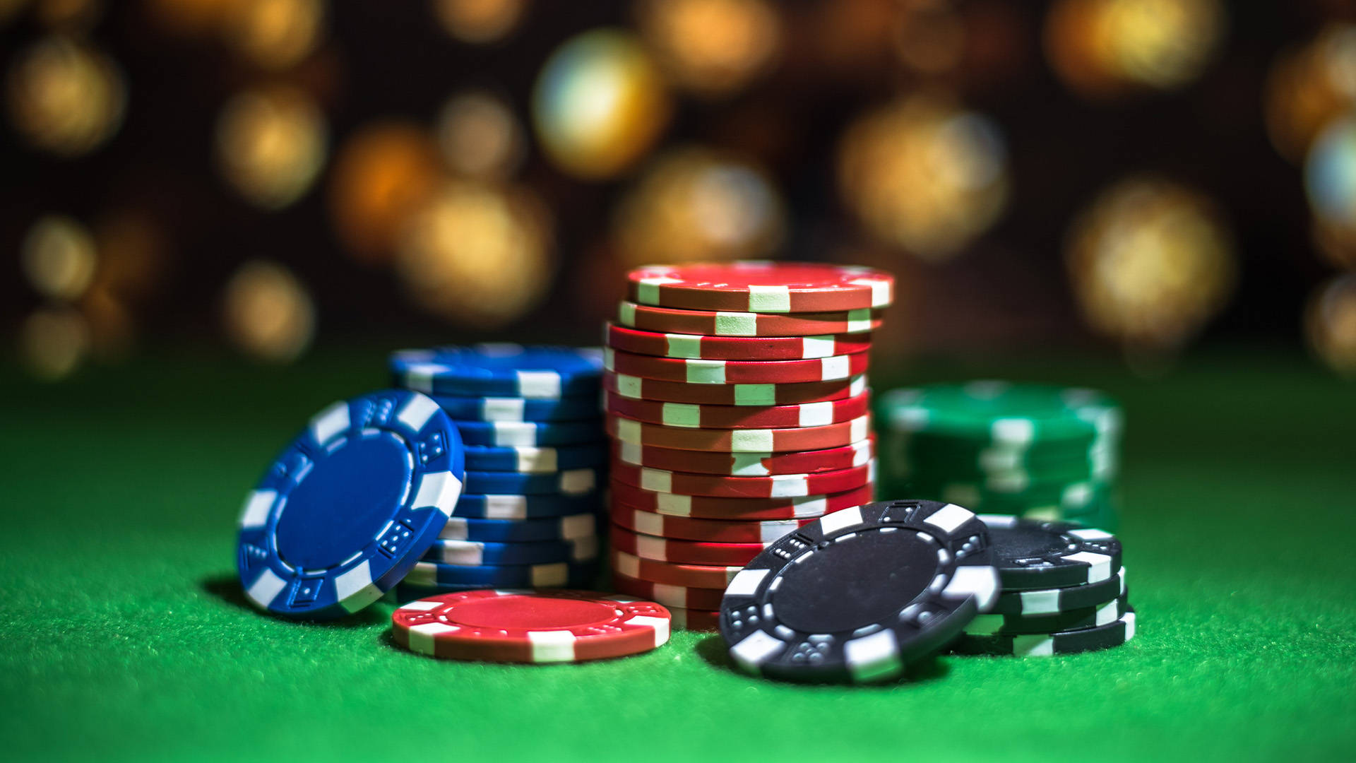 stack of casino chips on a green table