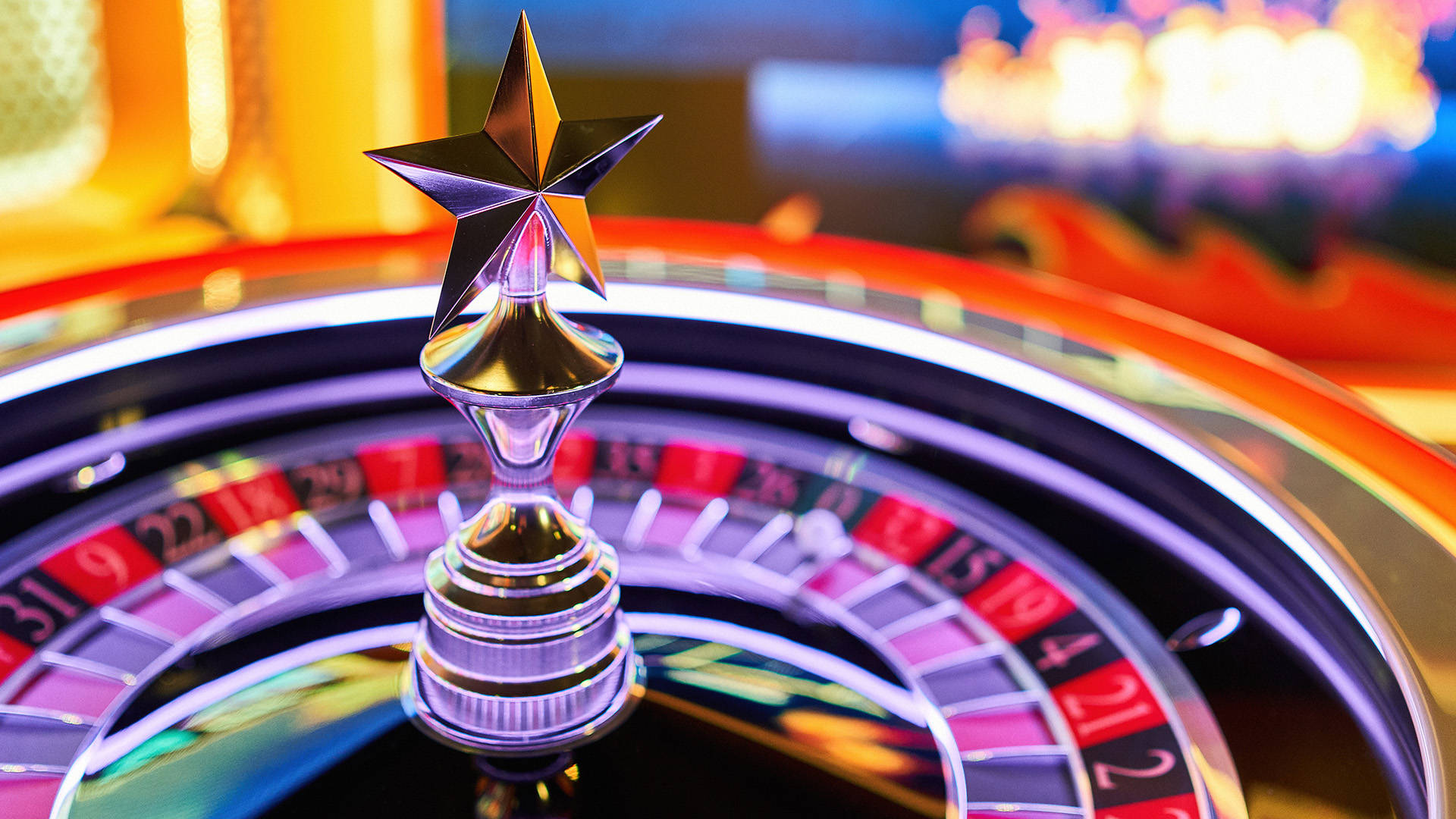 roulette wheel illuminated by bright colors in the backdrop