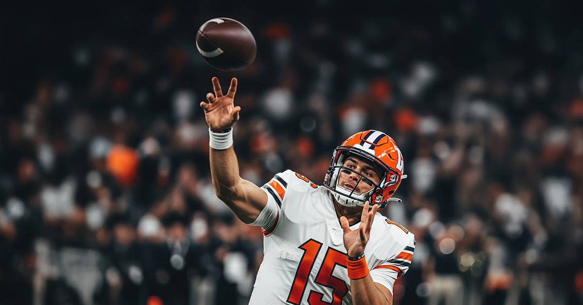 football player throwing the ball with fans in the background