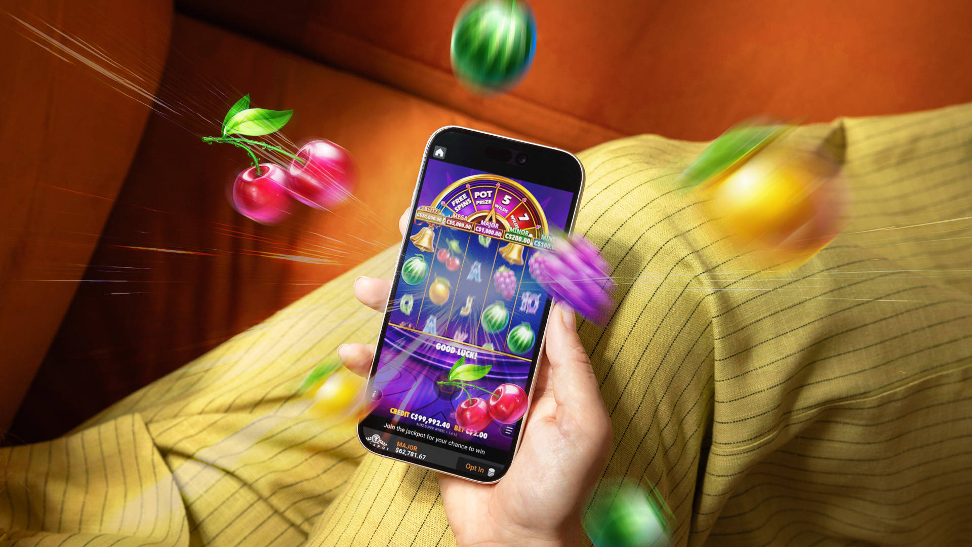 mobile affichant une machine à sous vidéo avec des fruits qui jaillissent de l'écran