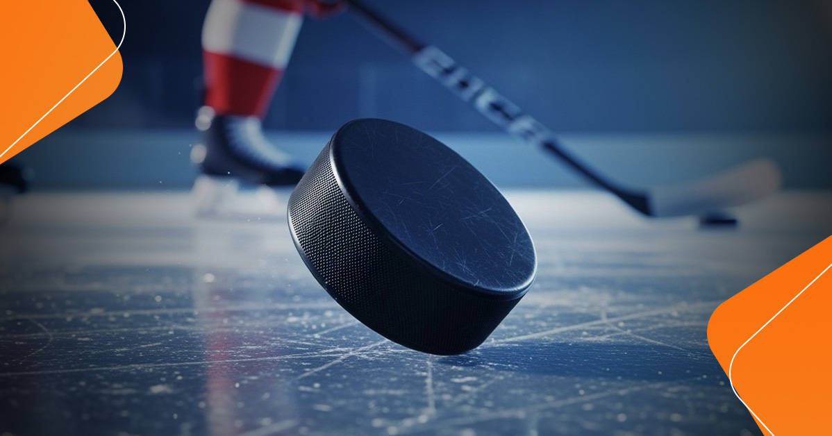 hockey puck balancing on one edge on the ice