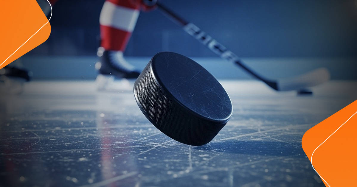 hockey puck balancing on one edge on the ice