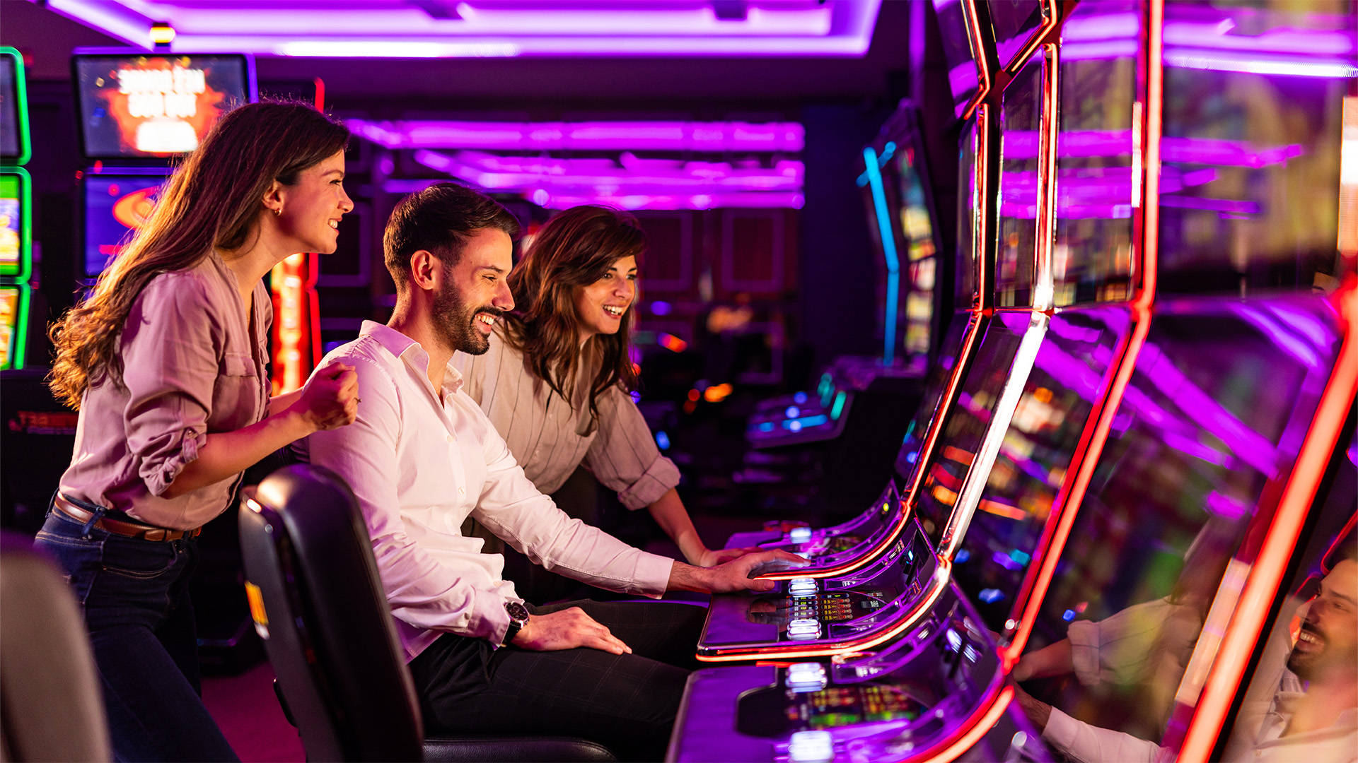 people playing at a physical land based slot machine