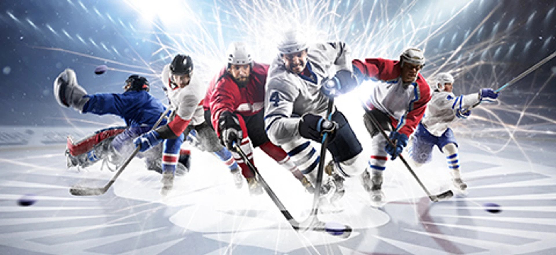 Ishockeyspillere i fuld fart midt i kamp på isen, med puck og stav