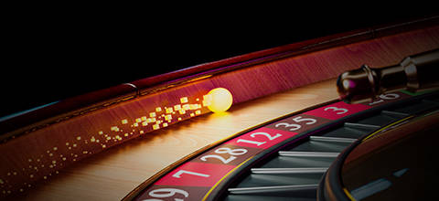 Roulette wheel with a ball landing on a number.