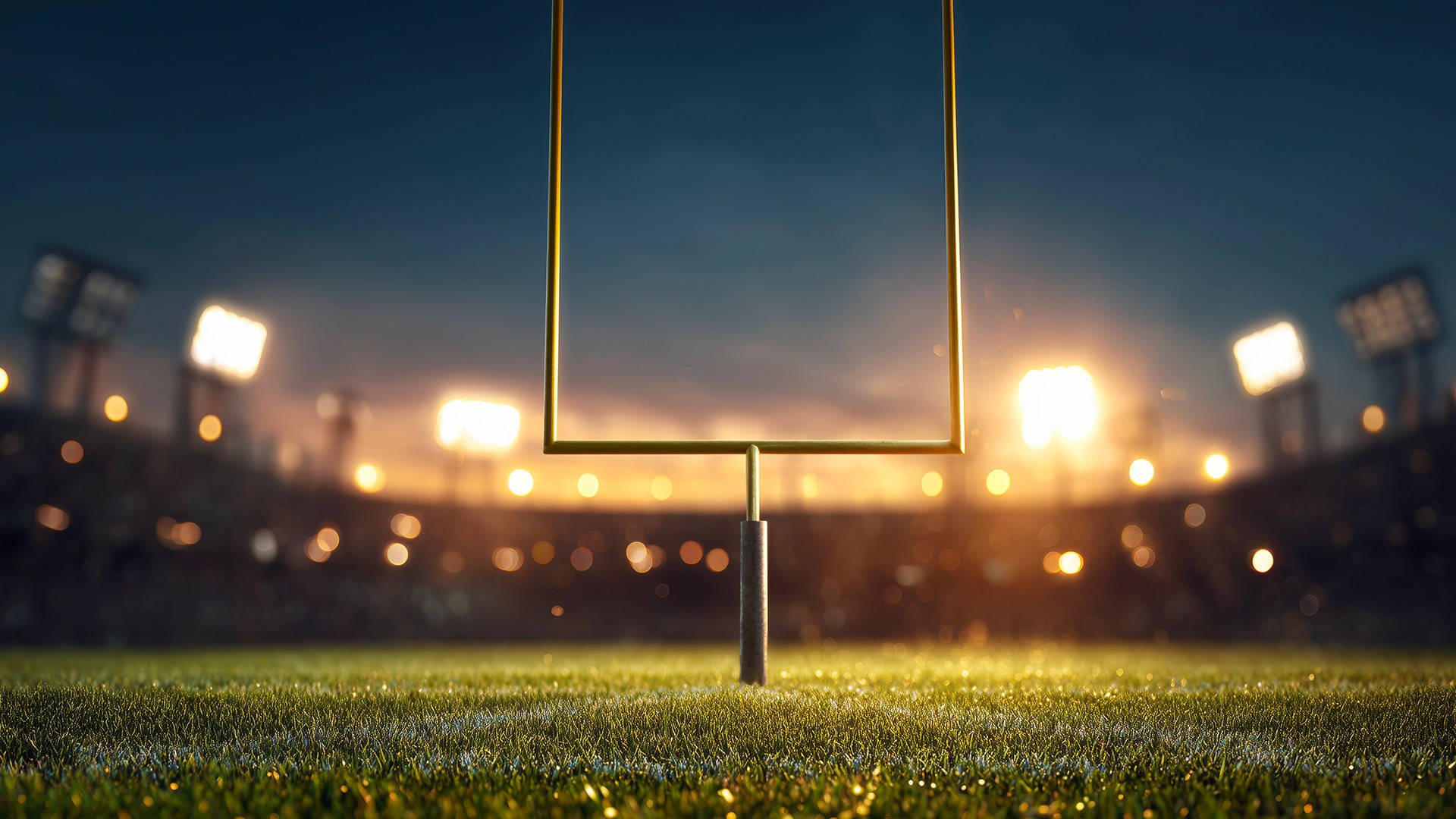 image of football goal posts with stadium lights illuminating them